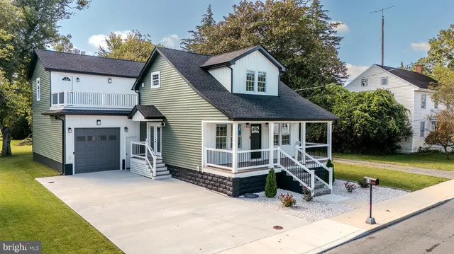 a view of a house with a swimming pool and sitting area