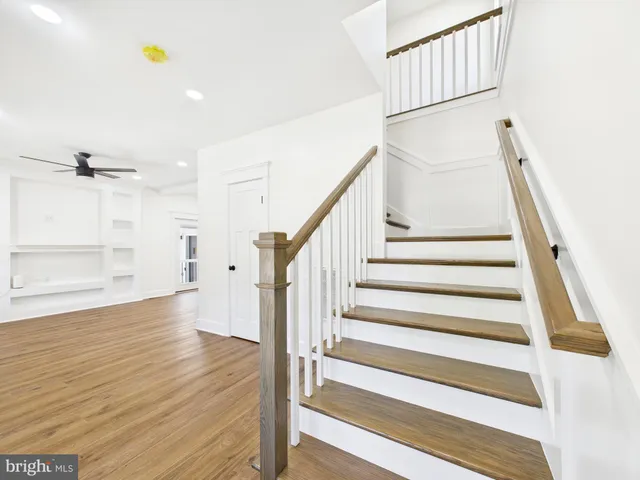 a kitchen with stainless steel appliances granite countertop a sink a stove and a wooden floors