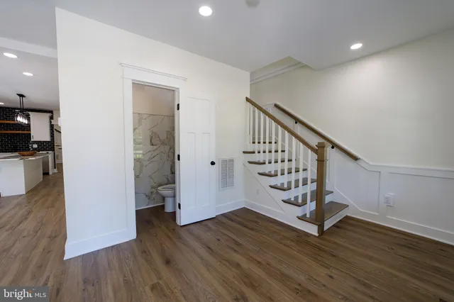 a view of a room with wooden floor and windows