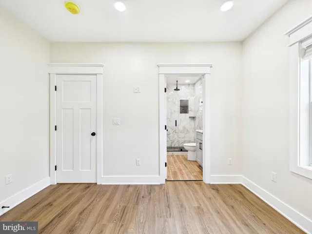 a view of a room with wooden floor