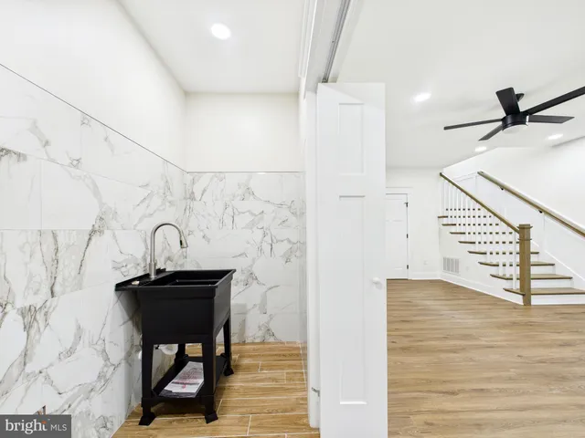an empty room with a window and a ceiling fan