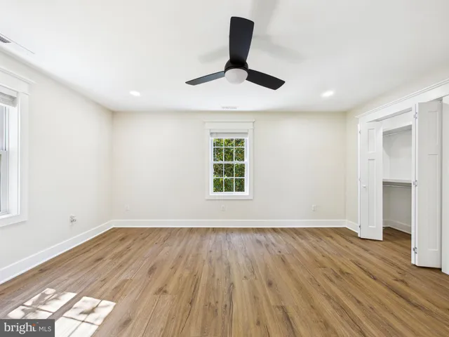 a front view of a house with a garden and parking