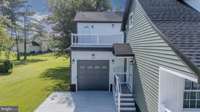 a kitchen with stainless steel appliances granite countertop a sink a stove a refrigerator and cabinets