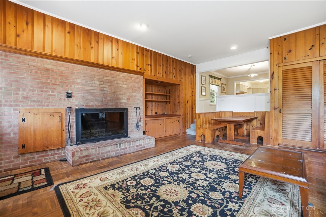 6119 Flemington Road Dayton, OH 45459 - Photo 22 of 76 Warm and inviting living space with a focal fireplace and built-in dining, perfect for cozy gatherings.