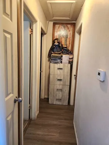 a view of a storage and utility room with wooden floor