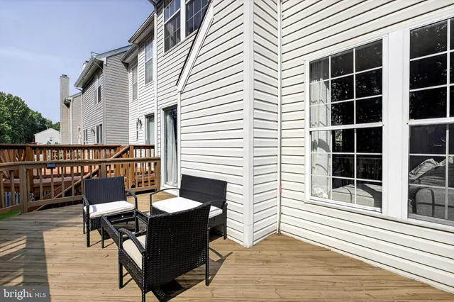 a view of a deck with table and chairs and wooden floor