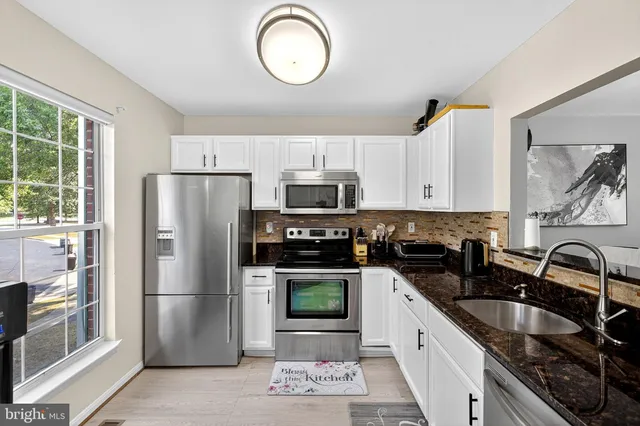a kitchen with a refrigerator sink and stove