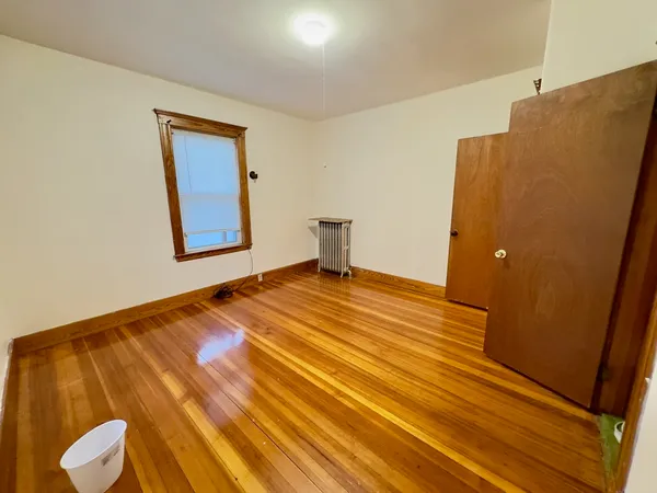 a bedroom with a bed and painting on the wall