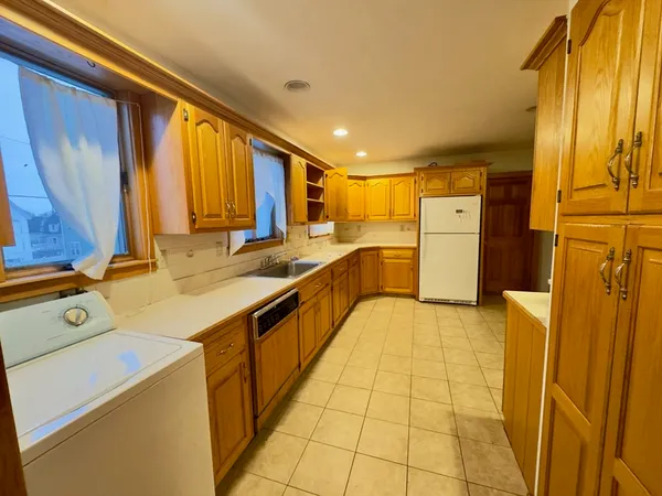 a view of a kitchen with a sink and dishwasher