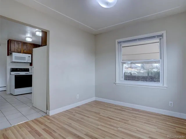 a white refrigerator freezer and a stove sitting inside of a kitchen