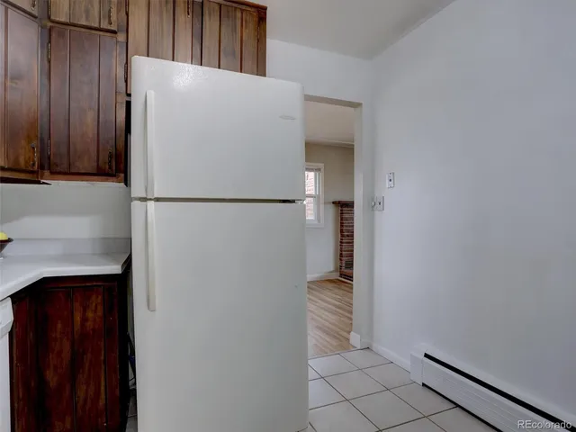 a white refrigerator freezer sitting inside of a kitchen