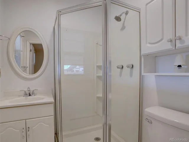 a view of an empty room with wooden floor and closet