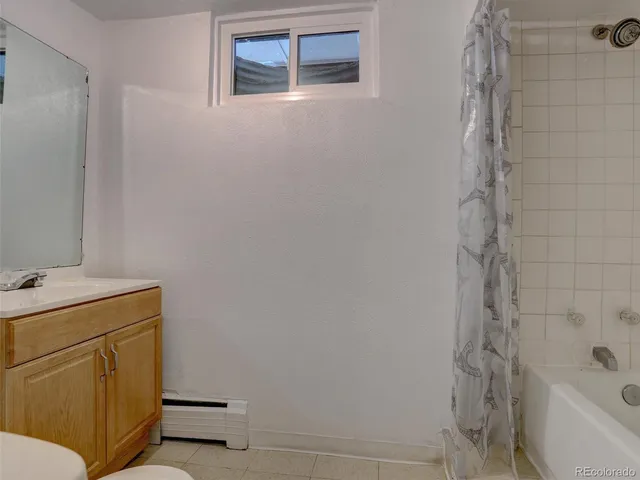 a view of house with outdoor space and trees in the background