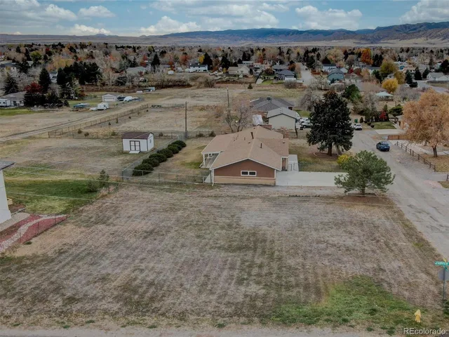 an aerial view of a house with a yard