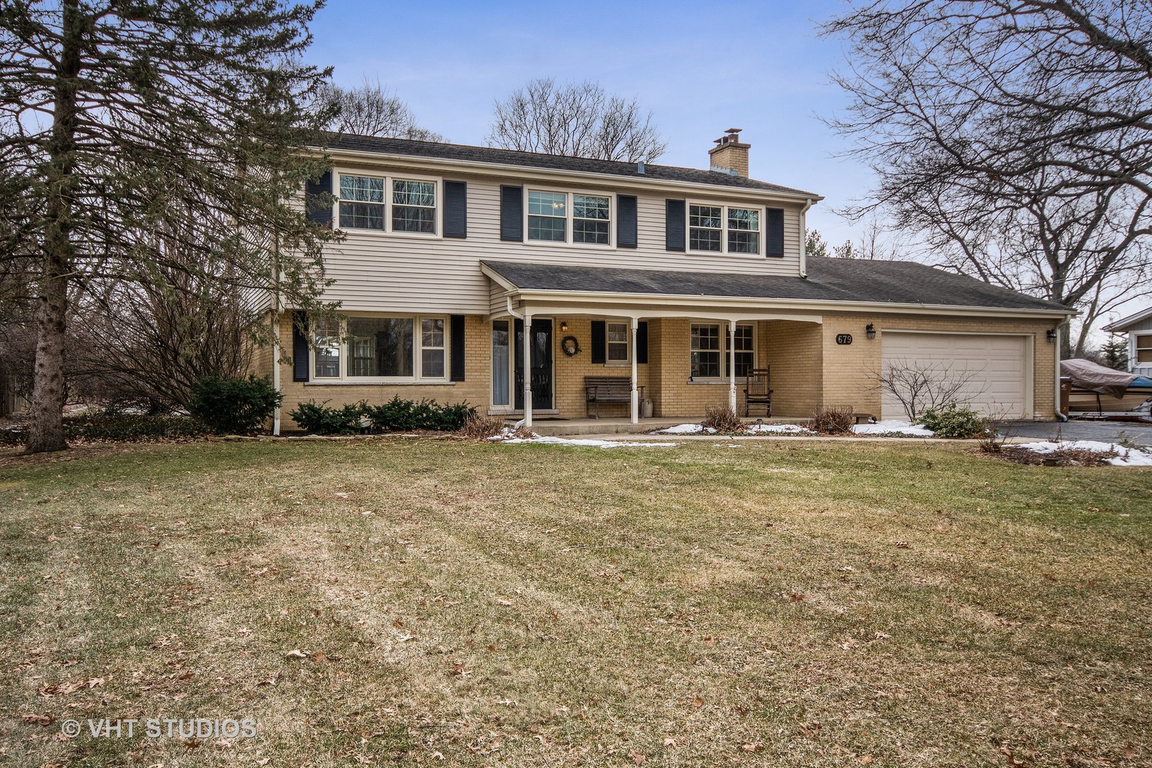a front view of a house with a garden