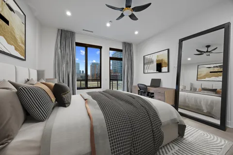 a bedroom with a large bed and a large window