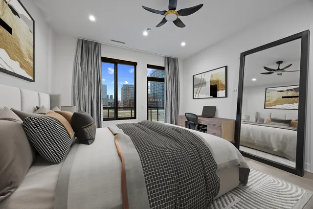 a bedroom with a large bed and a large window