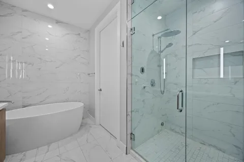 a bathroom with a bathtub and shower