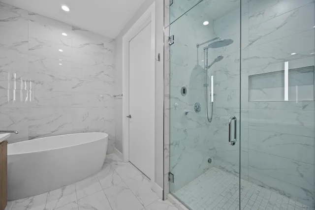 a bathroom with a bathtub and shower