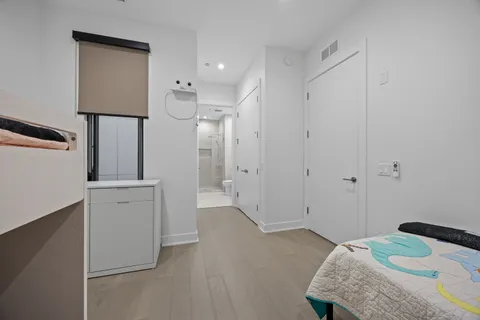 a bedroom with a bed and a hallway