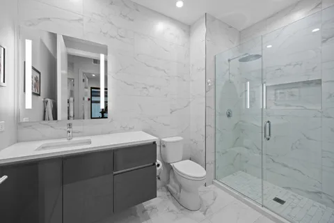 a bathroom with a toilet sink and shower
