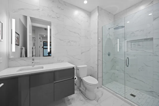 a bathroom with a toilet sink and shower