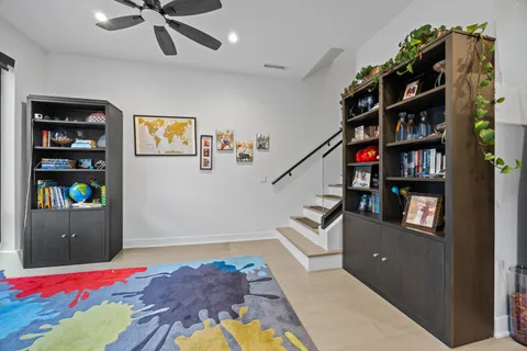 a bedroom with furniture and book shelf
