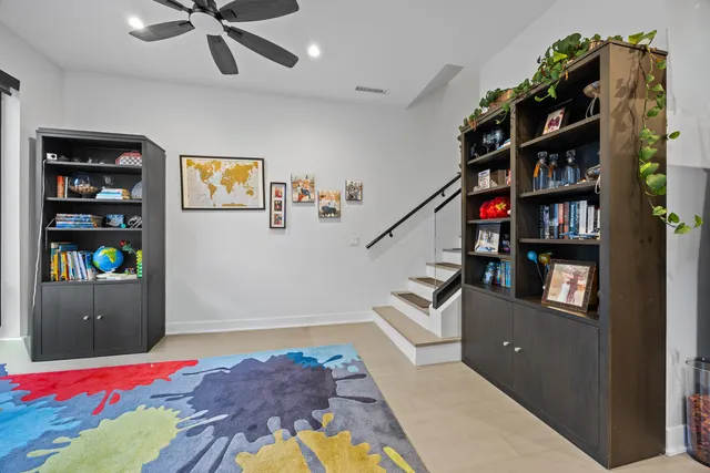 a bedroom with furniture and book shelf