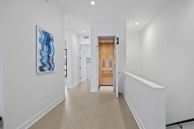 a view of a hallway with wooden floor
