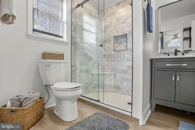 a bathroom with a toilet sink and shower