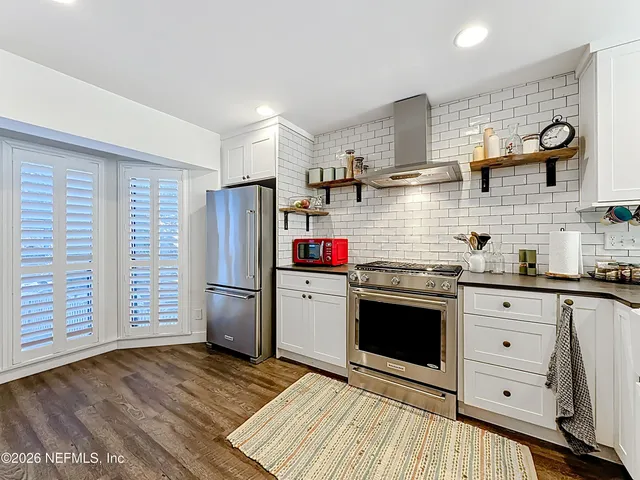 a view of a backyard with a large tree