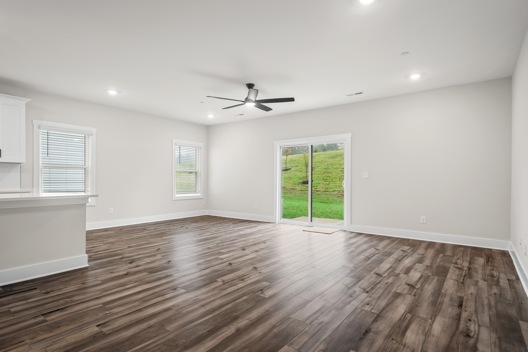 4015 Norman Drive Spring Hill, TN 37174 - Photo 3 of 11 a view of an empty room with a window and wooden floor