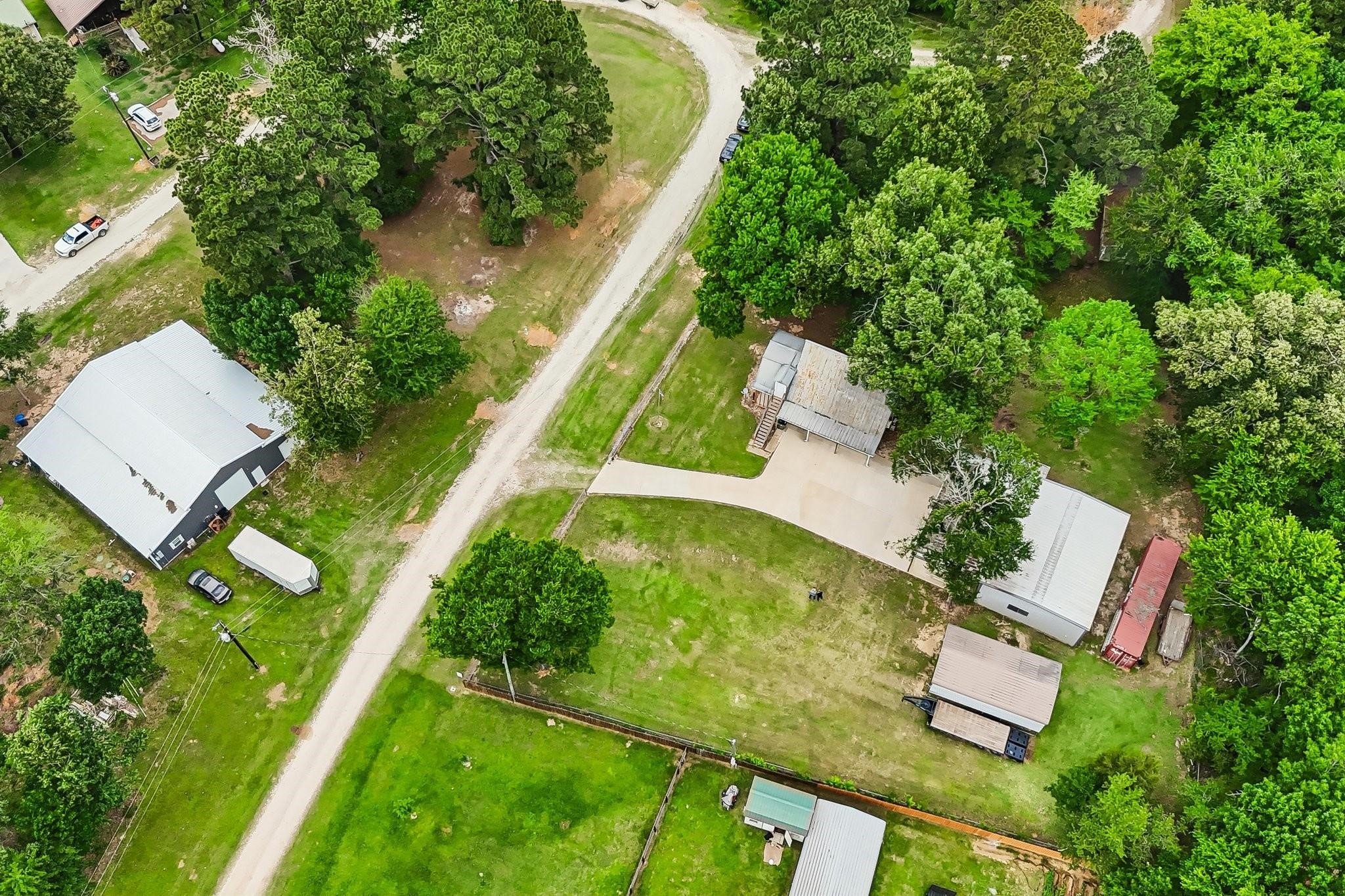 164 Frank Road Trinity, TX 75862 - Photo 11 of 20 11. Curb appeal meets security with this gated entrance. A long, pristine concrete driveway leads you into the heart of the property, offering a warm welcome and a sense of total privacy.