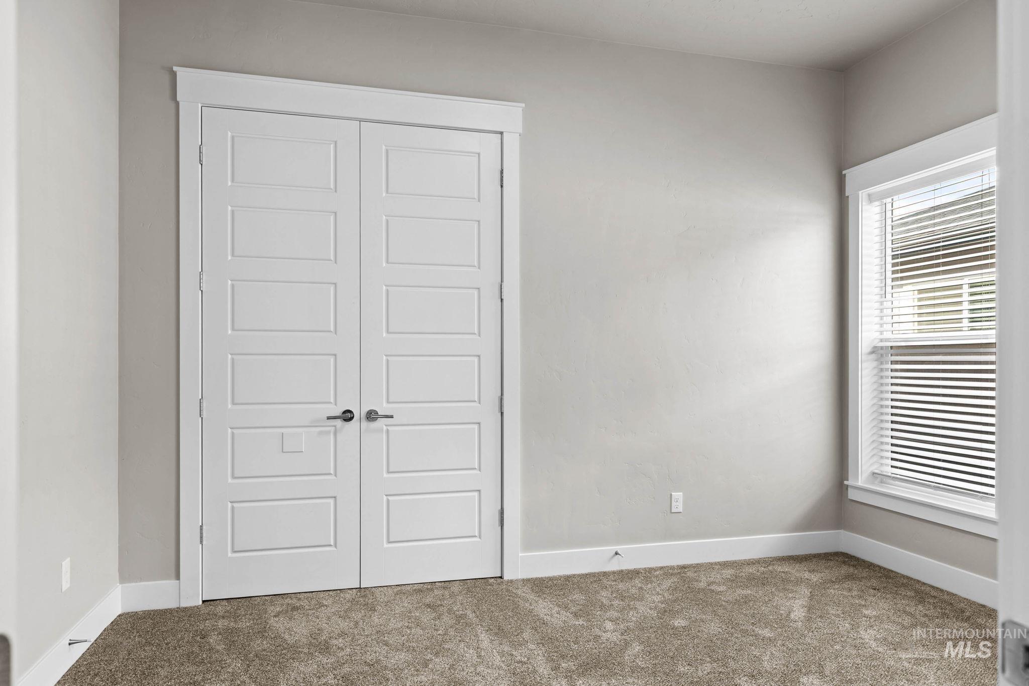2934 East Murchison Street Meridian, ID 83642 - Photo 31 of 44 Room featuring neutral wall tones, plush carpeting, a single window with blinds, and white trim throughout