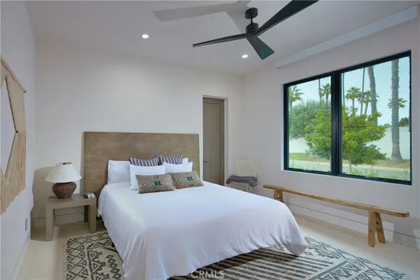 a bedroom with a large bed and a large window