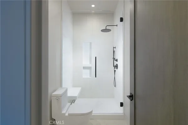 a bathroom with a granite countertop bathtub shower and toilet