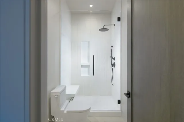 a bathroom with a granite countertop bathtub shower and toilet