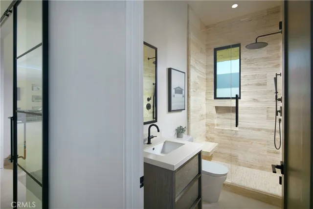 a bathroom with a sink toilet and shower