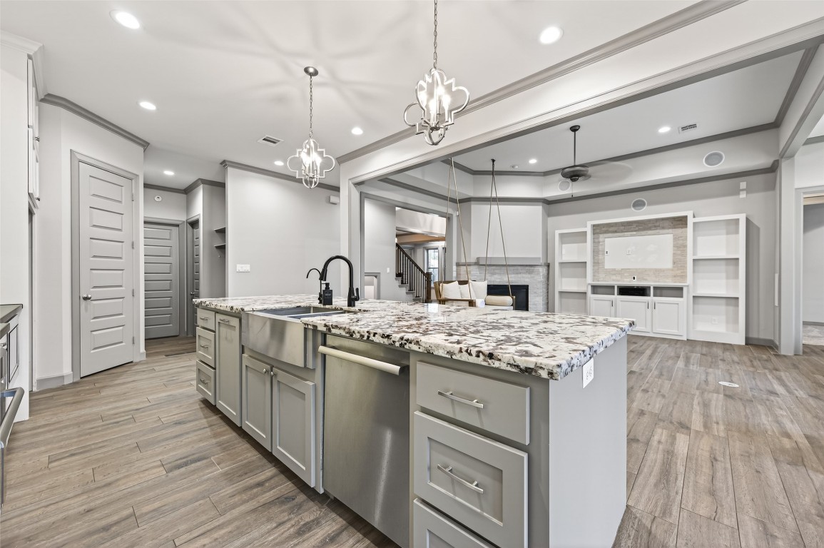 12379 Pebble View Drive Conroe, TX 77304 - Photo 13 of 49 a kitchen with stainless steel appliances granite countertop a sink cabinets and wooden floor