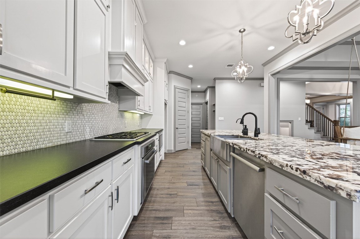 12379 Pebble View Drive Conroe, TX 77304 - Photo 14 of 49 a large kitchen with stainless steel appliances granite countertop a lot of counter space