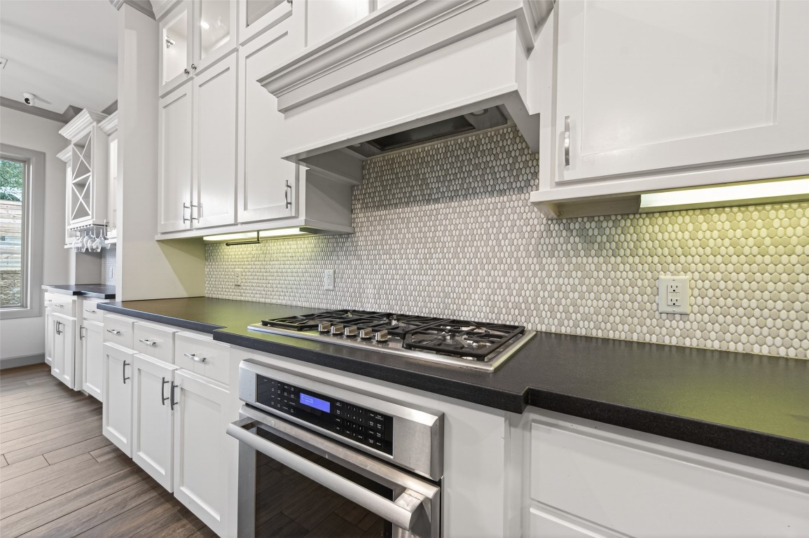 12379 Pebble View Drive Conroe, TX 77304 - Photo 15 of 49 a kitchen with granite countertop a stove and a sink