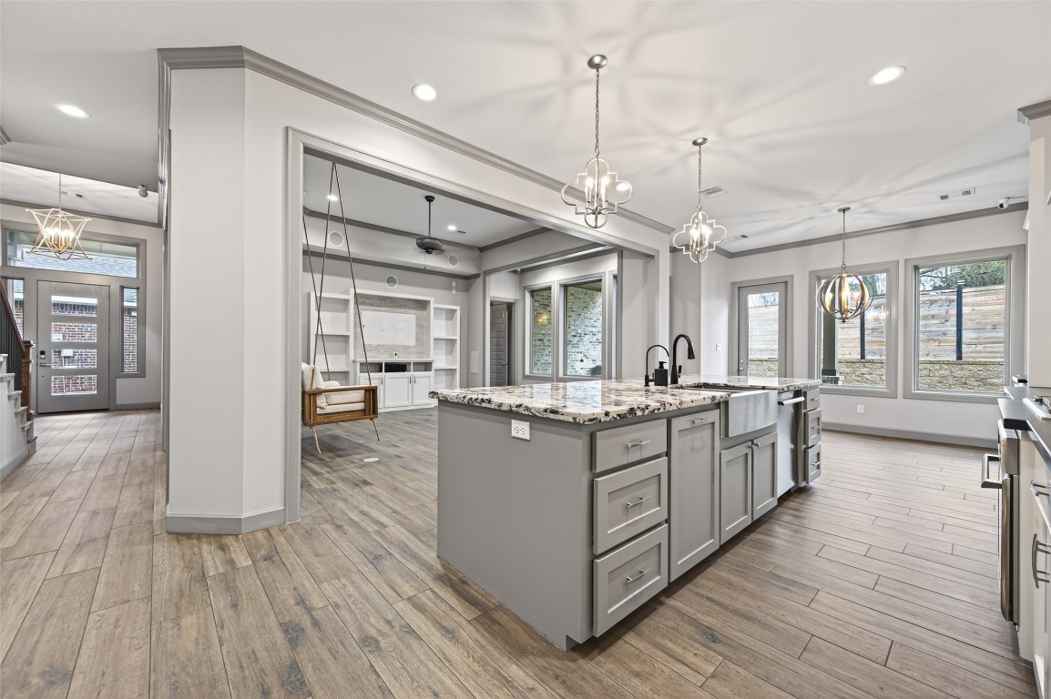 12379 Pebble View Drive Conroe, TX 77304 - Photo 16 of 49 a large kitchen with stainless steel appliances granite countertop a large center island and a wooden floors