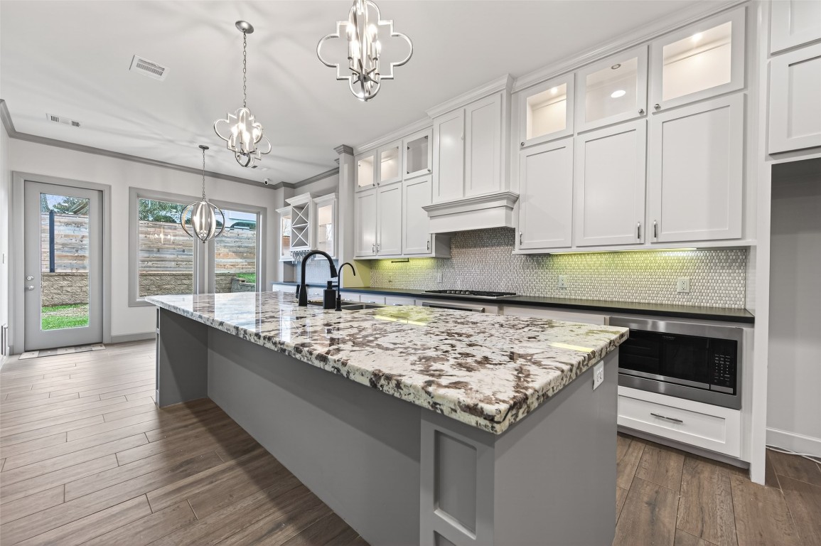 12379 Pebble View Drive Conroe, TX 77304 - Photo 18 of 49 a kitchen with stainless steel appliances granite countertop a sink stove and refrigerator