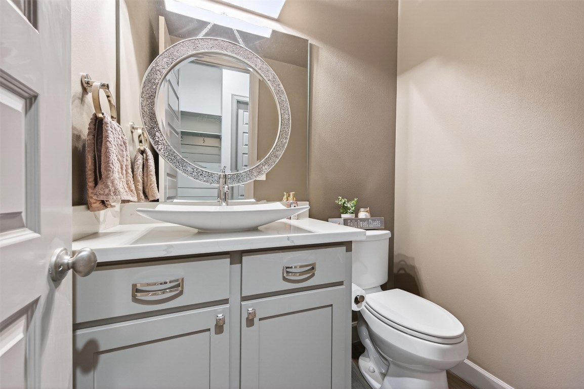 12379 Pebble View Drive Conroe, TX 77304 - Photo 19 of 49 a bathroom with a granite countertop toilet sink and mirror