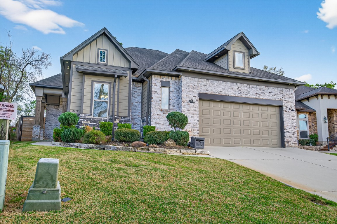 12379 Pebble View Drive Conroe, TX 77304 - Photo 2 of 49 a front view of a house with garden