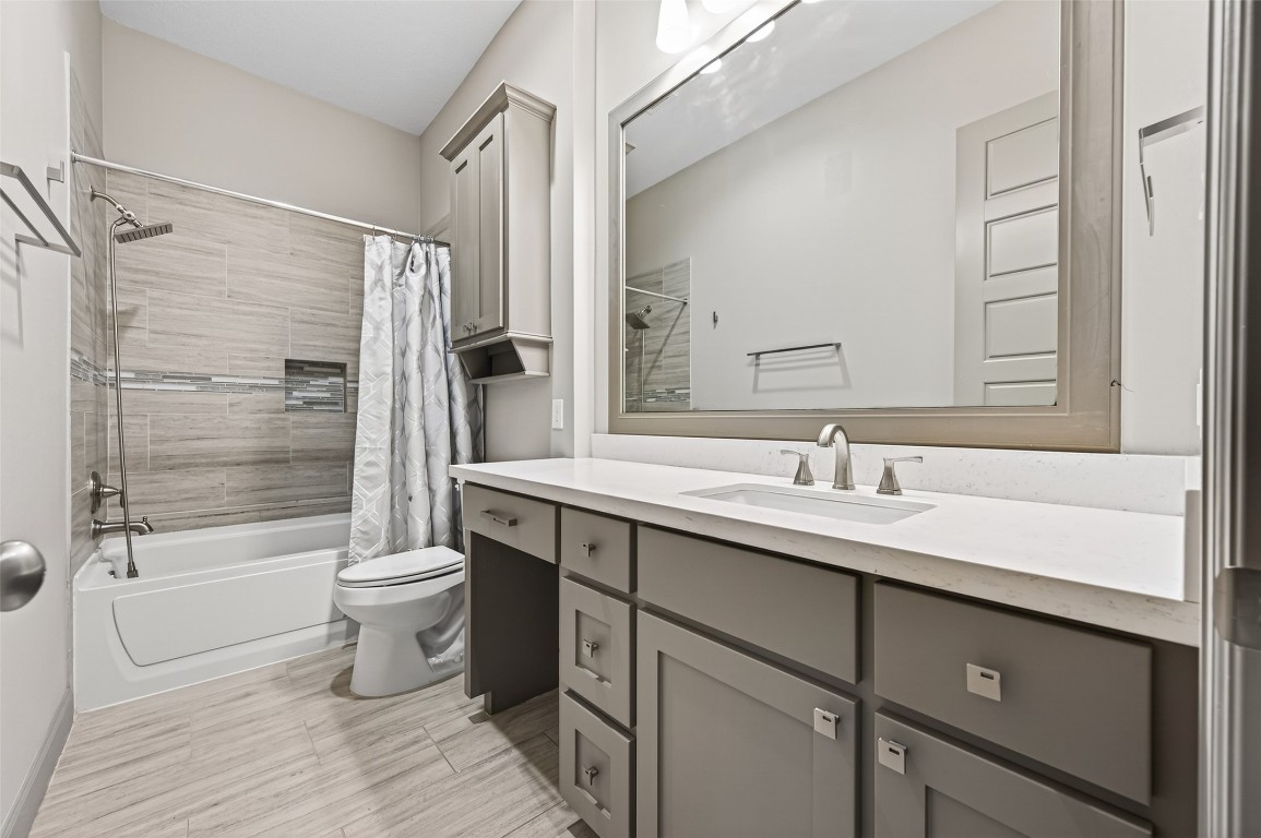 12379 Pebble View Drive Conroe, TX 77304 - Photo 23 of 49 a bathroom with a sink toilet a mirror and shower