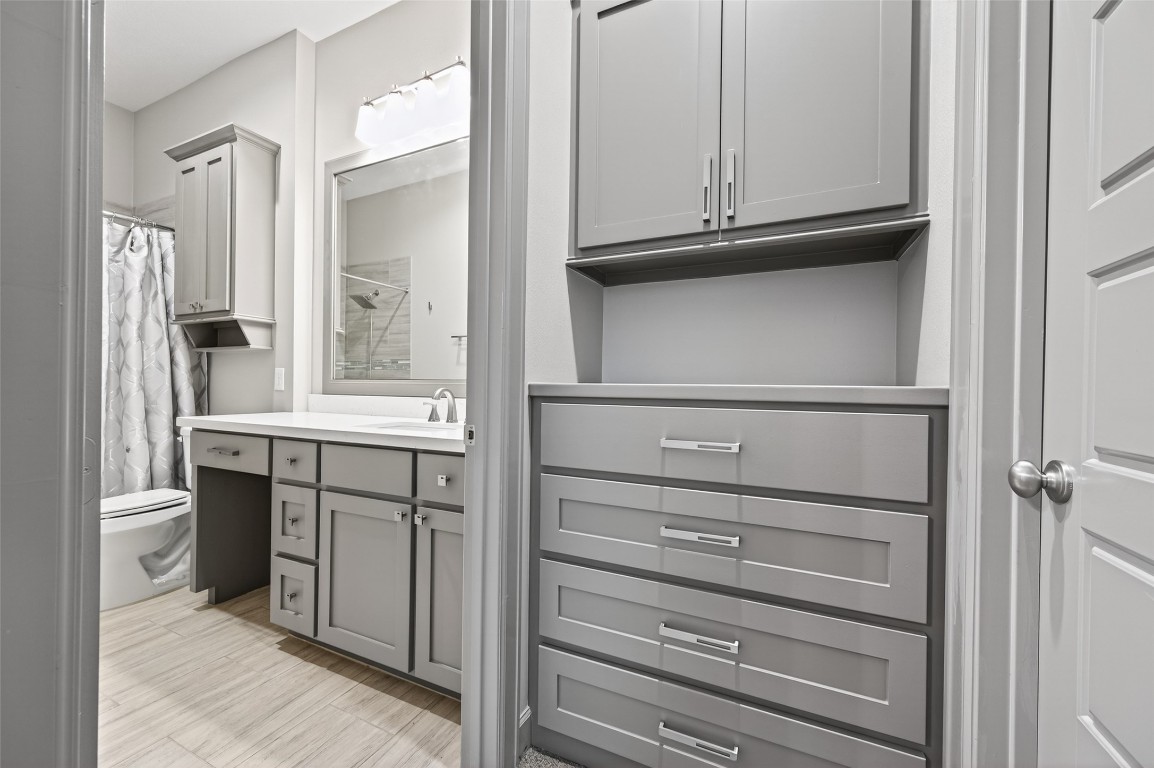 12379 Pebble View Drive Conroe, TX 77304 - Photo 24 of 49 a kitchen with white cabinets and a refrigerator