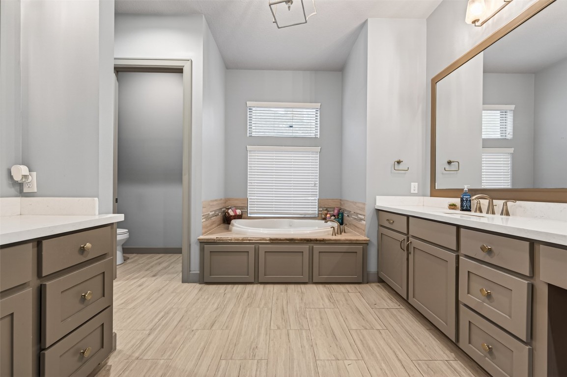 12379 Pebble View Drive Conroe, TX 77304 - Photo 27 of 49 a spacious bathroom with a double vanity sink a mirror and a bathtub