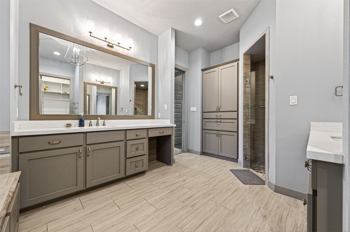 12379 Pebble View Drive Conroe, TX 77304 - Photo 30 of 49 a spacious bathroom with a double vanity sink and a mirror