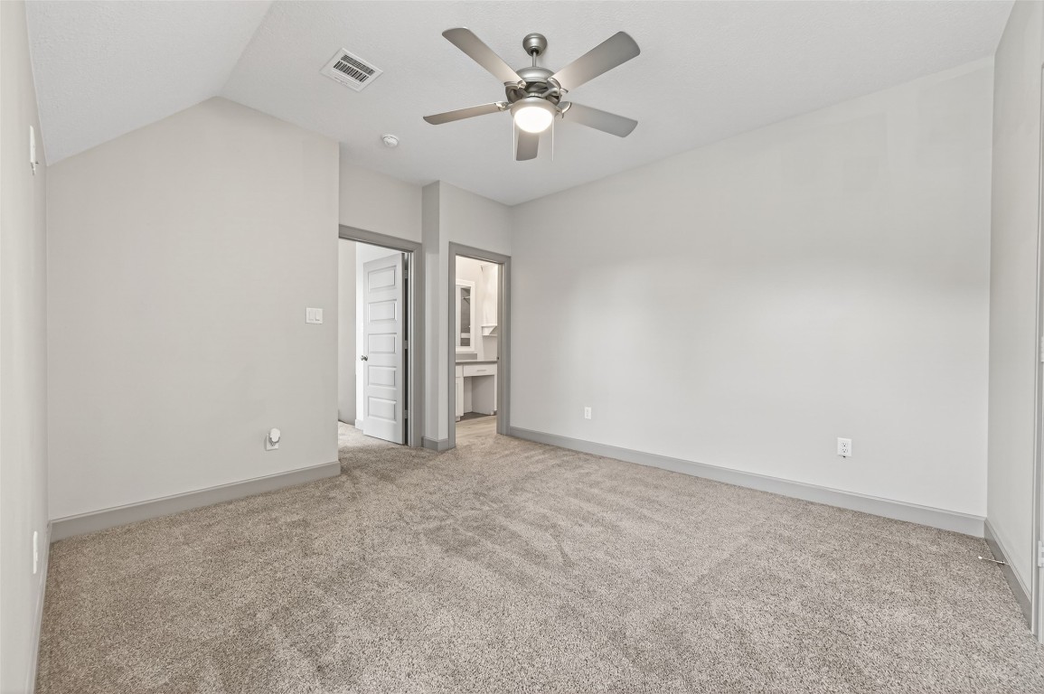 12379 Pebble View Drive Conroe, TX 77304 - Photo 34 of 49 an empty room with closet and a ceiling fan